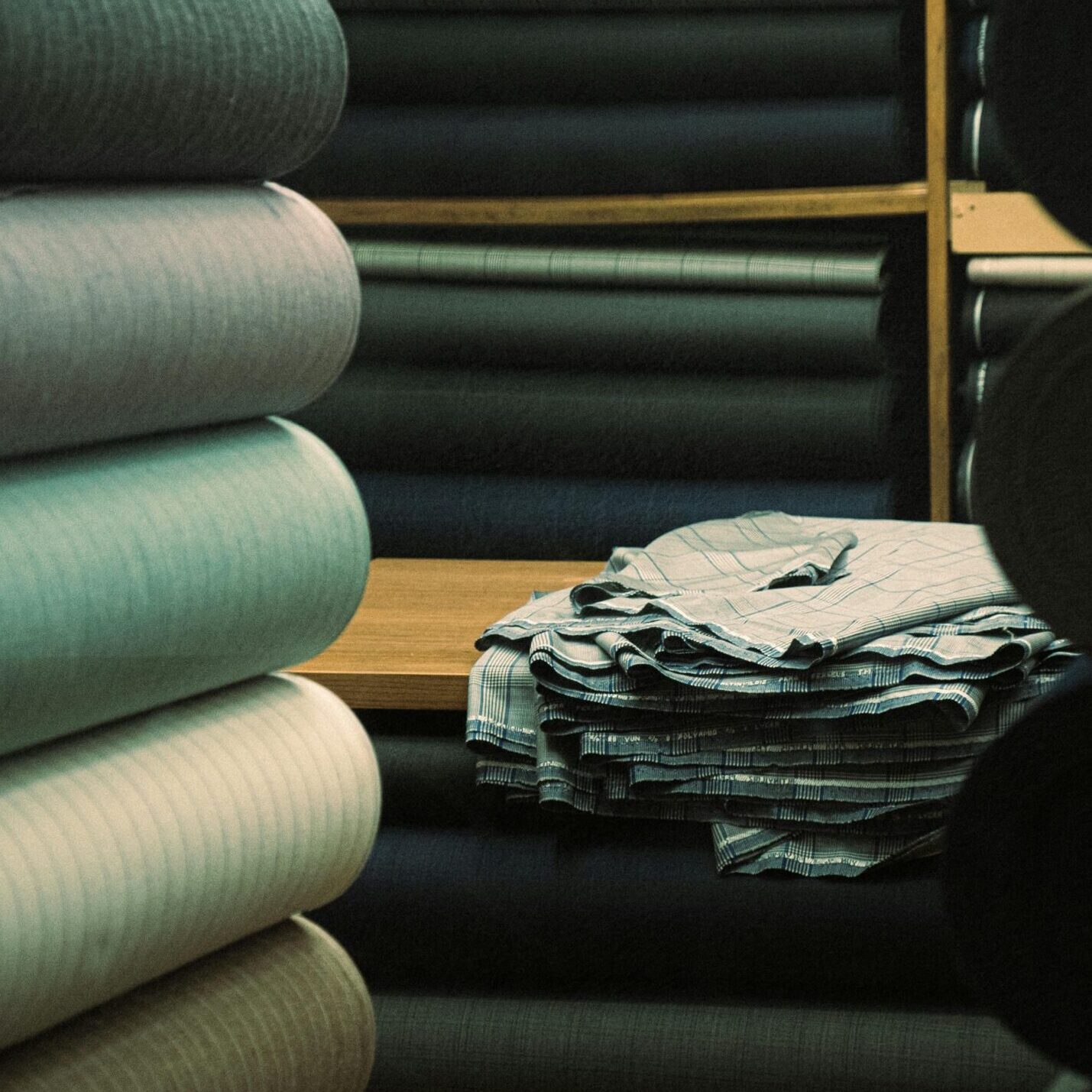 A variety of textile rolls on display in an İstanbul warehouse, showcasing fabric textures.